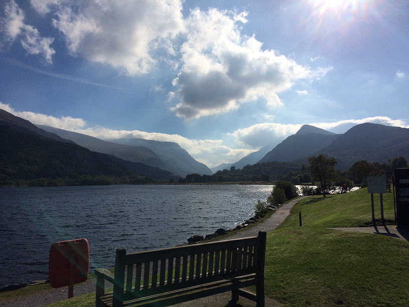 A view of Padarn Lake on a sunny day. Beautiful blue skies with Snowdon in the distance