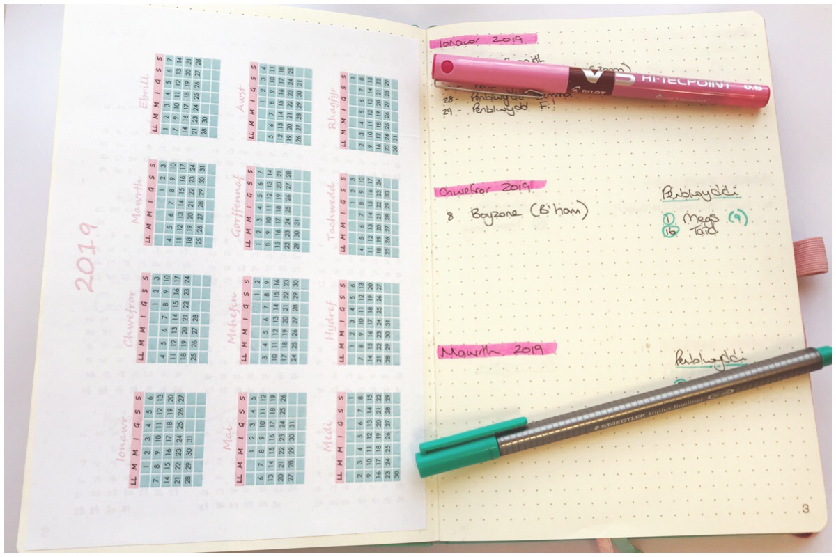 A photo of my bullet journal open on the calendar page which you can download.