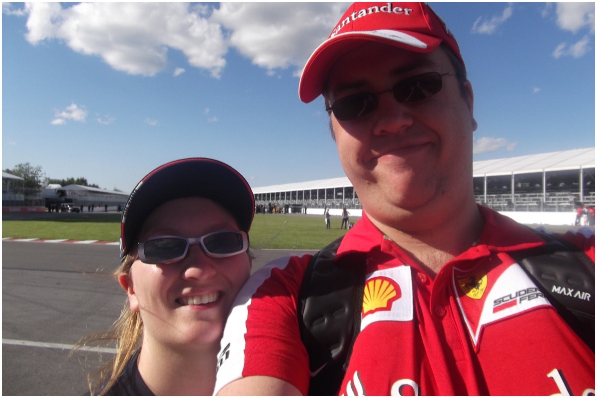 Rebecca & husband stood on the track of the Canadian Grand Prix with blue sky in background