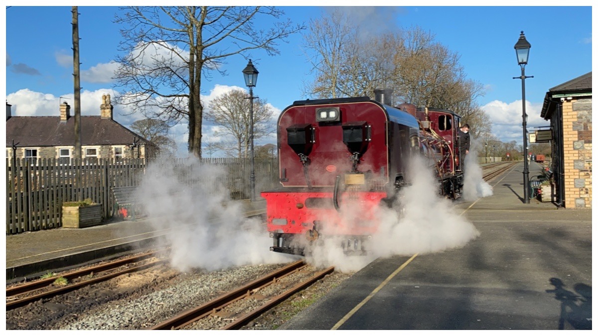 Ffestiniog & Welsh Highland Railways red Garratt 130 steaming at Dinas Station