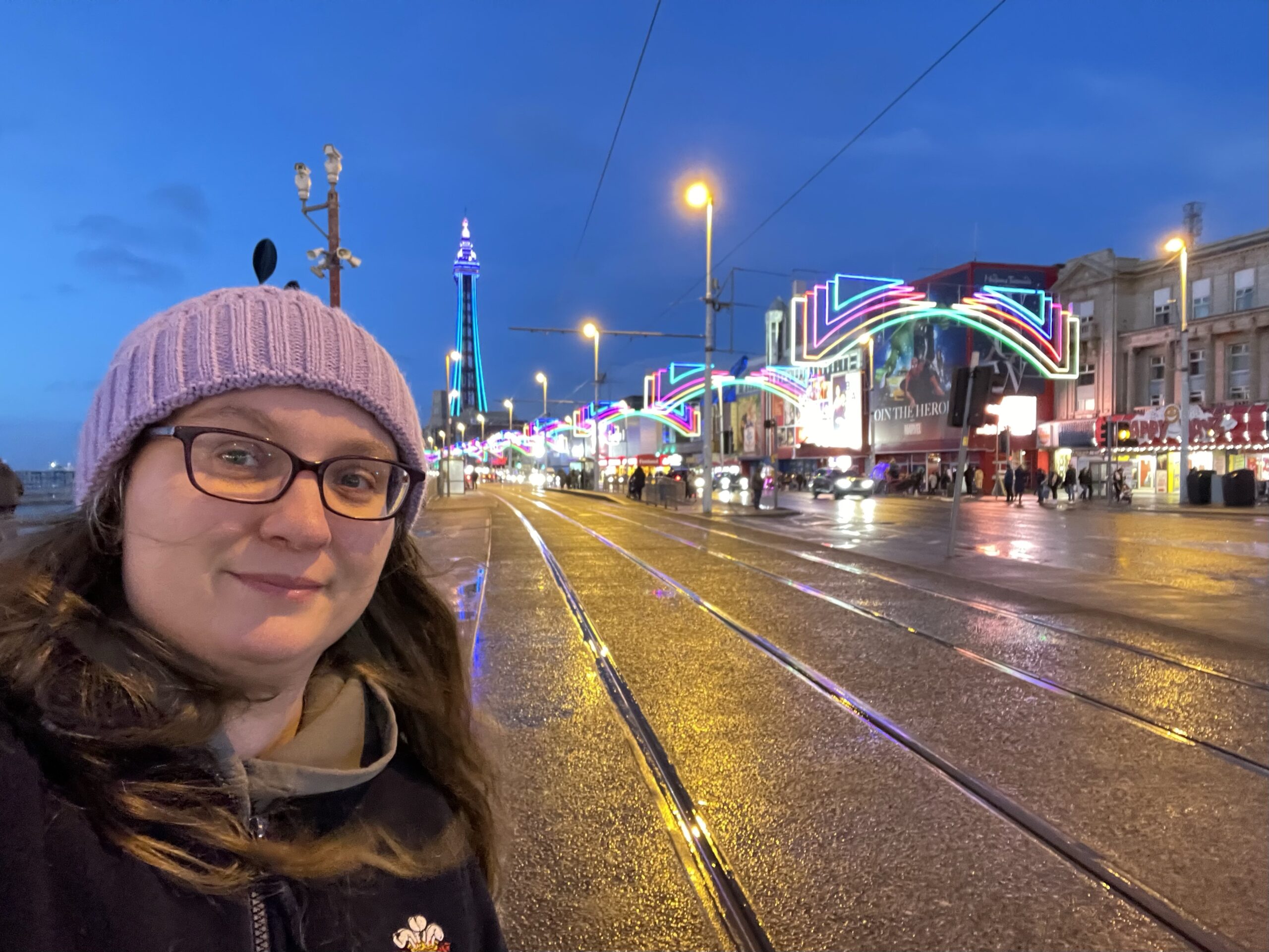 Selfie of Rebecca with Blackpool Tower and lights in the background